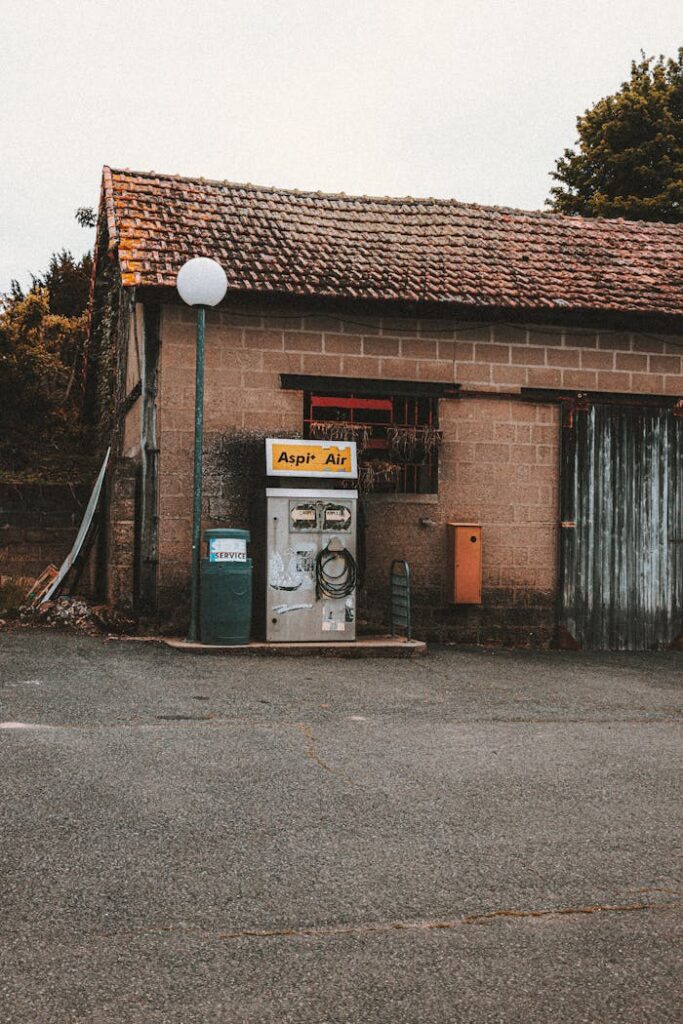 An old air pump and brick garage with a rustic charm set in a rural location.